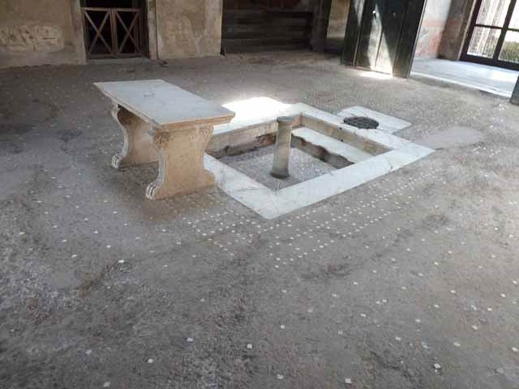 III.11 Herculaneum. May 2010. Room 6, looking south-west across impluvium and atrium floor of opus signinum decorated with a pattern of white tiling.